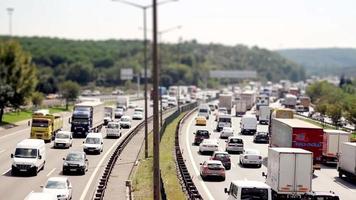 Heavy highway traffic, cars moving on highway, selective focus, noise effect, time lapse video