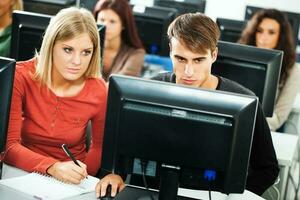 Students learning in a computer lab photo