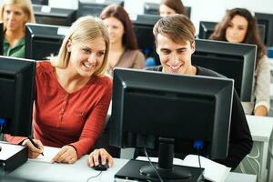 Students learning in a computer lab photo