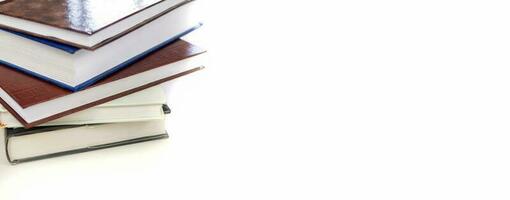 Stack of study books on white background. University books. Education concept. photo