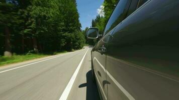 Vehicle Pov car is driving on a scenic road. Dense forest near the highway. video