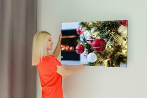 Canvas prints. A woman holding photo canvas. photo printed on glossy synthetic canvas and stretched on wooden stretcher bar