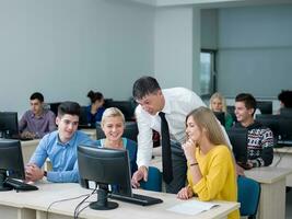 students with teacher  in computer lab classrom photo