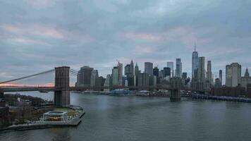 Skyline of Lower Manhattan and Brooklyn Bridge in the Evening, New York City. Day to Night Time Lapse video