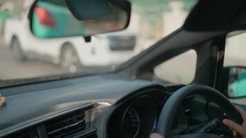 Female driver turns the steering wheel in the car A woman drives an automatic transmission car and uses the car's controls video