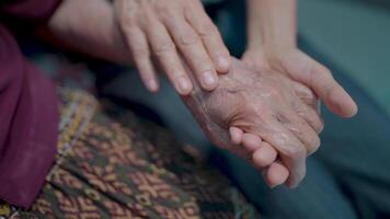 Happy family concept A daughter's rise in the hands of an elderly guardian A mother's hand holding her child's hand shows her love and concern for the child. Family support video