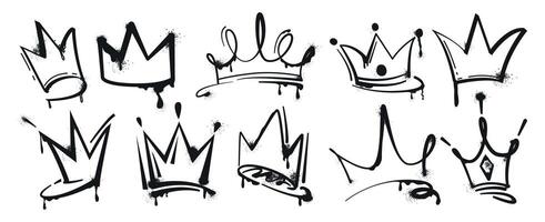 Set of graffiti spray painted crowns. Black brush paint king crown isolated on white background. Hand drawn street art vector illustration. Grunge airbrush drawing, inky elements with splashes