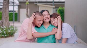 The two children hugged their mother with love and care. Looking at the camera smiling as a cute family. video