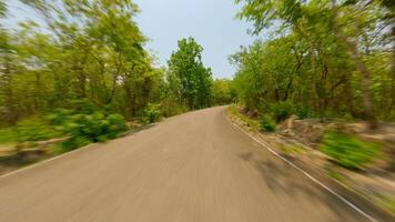 Fast FPV flight over tropical road through green forest in Thailand in summer video