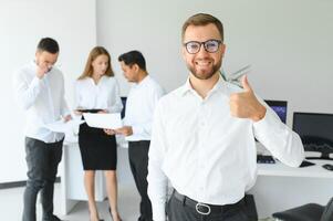 Business people stand on the background of the office corridor photo