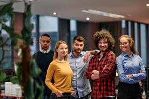 Portrait of successful creative business team looking at camera and smiling. Diverse business people standing together at startup. Selective focus photo