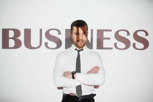 A young and successful businessman. Business concept. The word business on the background. photo