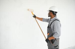 painter man painting the wall, with paint roller photo