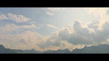 Cinematic time lapse of morning cloudscape under sunlight above mountain range. Fast motion dramatic cloudy blue sky over the valley. Beautiful nature outdoor landscape wide screen. video