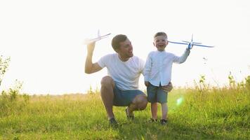 Father and child teamwork, family dreams and fantasies. Happy family dad, baby, son play together with toy plane video