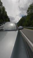 Car driving on an asphalt road. Windscreen and hood view video