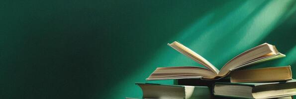 Stack of Open Books on a Green Background. Knowledge and Education Concept photo