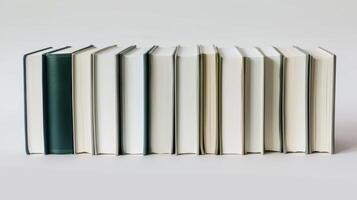 Line of books with understated covers is neatly arranged on a shelf photo