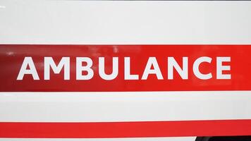 Large ambulance sign on the back door of the car. photo