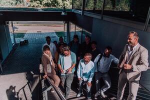 A diverse group of businessmen and colleagues walking together by their workplace, showcasing collaboration and teamwork in the company. photo