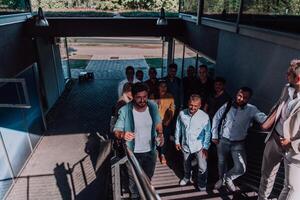 A diverse group of businessmen and colleagues walking together by their workplace, showcasing collaboration and teamwork in the company. photo