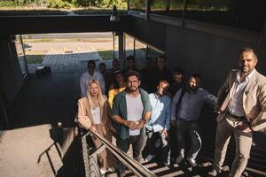 A diverse group of businessmen and colleagues walking together by their workplace, showcasing collaboration and teamwork in the company. photo