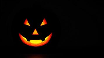 Close Up Of A Lit Jack-O'-Lantern In The Darkness photo