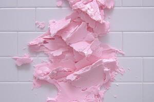 Crumpled pink frosting on white tiles photo