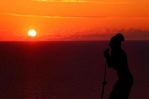 girl singing at sunset silhouette photo