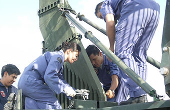 Image of people assembling radar equipment