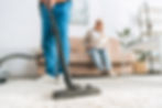 Caregiver Vacuuming Client's Home - Comprehensive In-Home Care Services