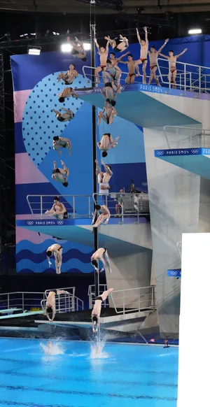 A composite image of two synchronized divers shows them completing four-and-a-half somersaults from the 10-meter platform, which won them the gold medal.