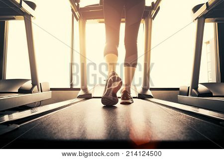 Lower Body At Legs Part Of Fitness Girl Running On Running Machine Or Treadmill In Fitness Gym With