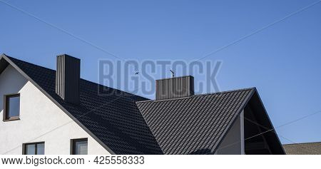 Grey Corrugated Metal Profile Roof Installed On A Modern House. The Roof Of Corrugated Sheet. Roofin