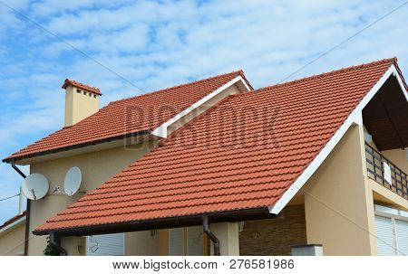 Modern House With Chimney, Red Clay Tiled Roof And Gable And Valley Type Of Roof Construction. Build