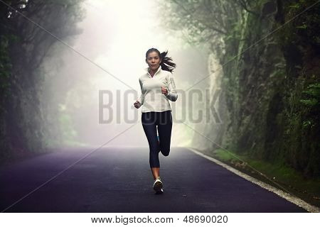 Nainen käynnissä tiellä. Naisten runner lenkkeily mountain road koulutusta maraton. Fit tyttö fitnes