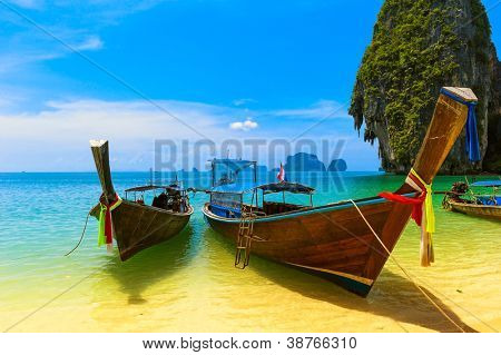 Travel landscape, beach with blue water and sky at summer. Thailand nature beautiful island and traditional wooden boat. Scenery tropical paradise resort.