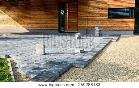 Laying Gray Concrete Paving Slabs In House Courtyard Driveway Patio.