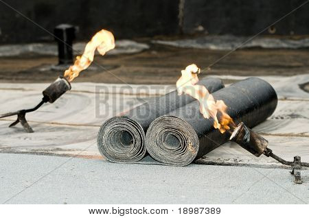 roofing felt roll and one torch blowpipes with open flame