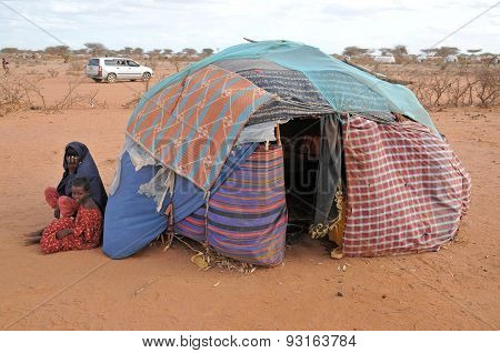 In Refugee Camps, Sitting Next To A Tent With The Child Woman