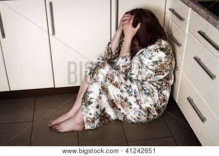 Adult woman crying sitting on the floor. Hopelessness, depressions, sadness, stress, grief, loneliness, problems.