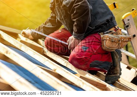 Craftsman Or Construction Worker Install A New Roof, Roofing Tools, New Metallic Roof Or Metal Sheet