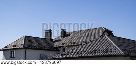 Brown Corrugated Metal Profile Roof Installed On A Modern House. The Roof Of Corrugated Sheet. Roofi