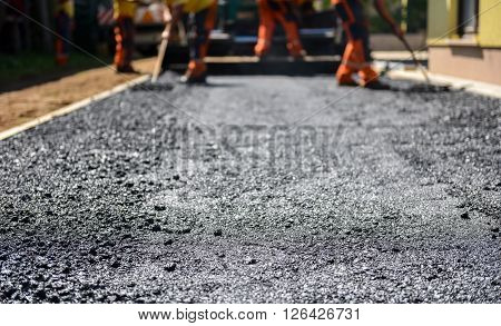 Team Of Workers Making And Constructing Asphalt Road Construction.