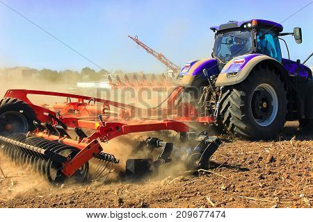 Agriculture. The Tractor Prepares The Ground For Sowing And Cultivation.    Work Of A Plow On The Fi