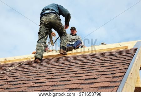 Kyiv, Ukraine - June, 23, 2020:roofing Contractors With Safety Ropes, Fall Protection Are Finishing 