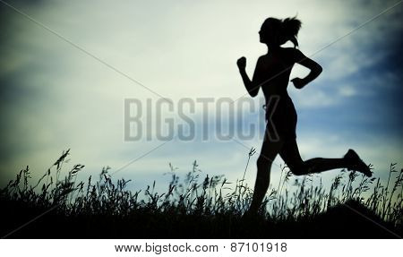 Young woman running summer park rural road. Outdoor exercises. J