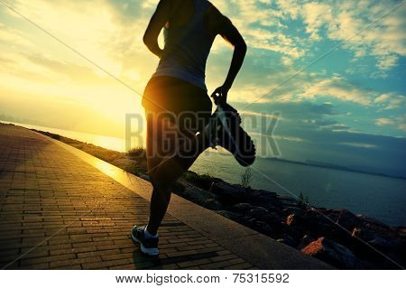 Runner athlete running at seaside. woman fitness silhouette sunrise jogging workout wellness concept