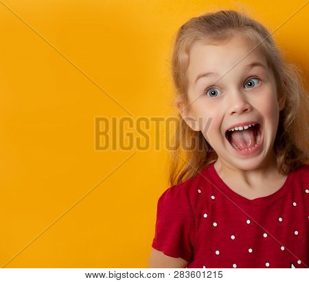 Beautiful Little Girl Reacting Emotionally Screaming In Shock Over Yellow Background