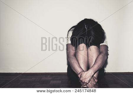 Depression. Depressed And Lonely Girl Abused As Young Sitting Alone In Her Room On The Floor Feeling